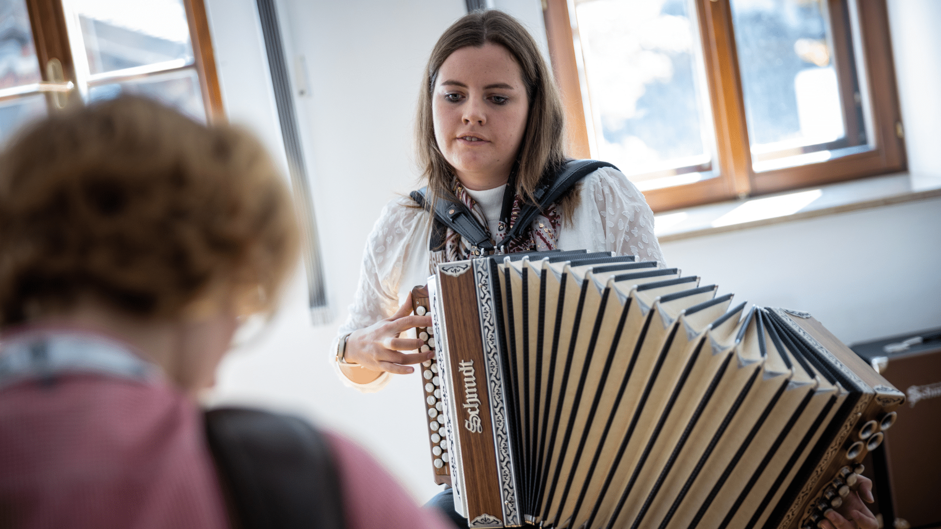 Harmonikaschülerin lernt den Bass zur Melodie auf der Steirischen
